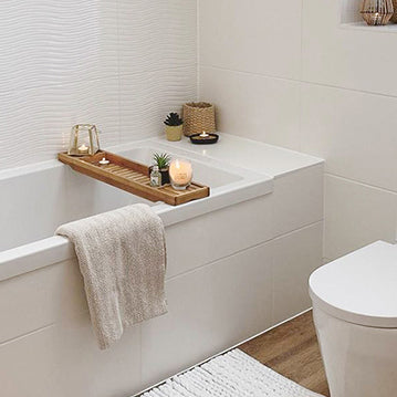 Image of a medium-sized bathroom. Featuring a standard shower bathtub, toilet and white tiled walls.