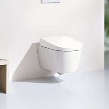 Image of a wall-hung smart toilet, which includes a bidet function, in a modern, white space.